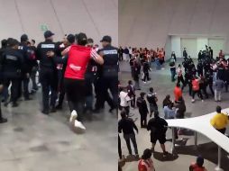 En un video difundido en redes sociales, se observa cómo el aficionado de las Chivas se acerca a un grupo de policías zapopanos quienes aparentemente atendían una riña en el Estadio Akron y golpea por la espalda a uno de ellos. ESPECIAL