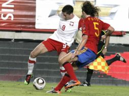 Puyol disputa el balón con Lewandowski, durante el partido amistoso. EFE  /
