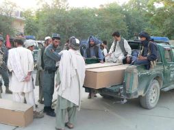 Familiares y policías cargan en una furgoneta los cadáveres de algunas de las víctimas del atentado. EFE  /