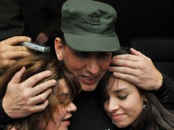 El ex cautivo de las FARC, Luis Mendieta, abraza a su hija y esposa en la sede de la Policía bogotana. AFP  /