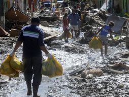 Damnificados transportan víveres y bienes donados, en Santana de Mundaú. EFE  /