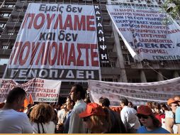 Empleados de la Empresa Nacional de Electricidad protestan frente a la sede de la compañía, en Grecia. AFP  /