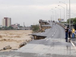 Gente observa una vía rápida destruida tras las fuertes lluvias dejadas por 'Alex' en Monterrey. REUTERS  /