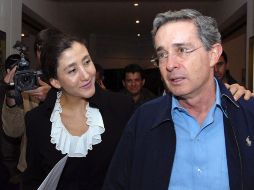 • Íngrid Betancourt tiende el brazo al presidente de Colombia, Álvaro Uribe, en Bogotá. AFP  /