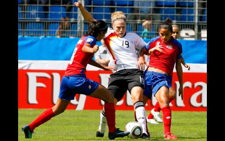 La futbolista alemana Kim Kulig (c), lucha por el balón con las costarricenses Daniela Cruz (izq.) y Mariela Campos. EFE  /