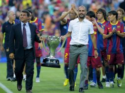 El presidente y el entrenador del Barcelona, sostienen la copa que les acredita como campeones de la liga 2009-2010. AP  /