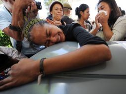 Ayer arribaron a Honduras los cuerpos de 16 personas que murieron en el rancho de Tamaulipas. AFP  /