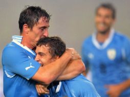 Los uruguayos celebrando sus anotaciones con las que consiguieron la victoria ante China. AFP  /