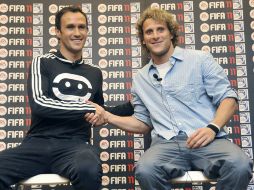 Ricardo Carvalho (Real Madrid) y Diego Forlán (Atlético) presentaron ayer un juego de video en la capital española. EFE  /