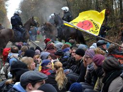 La Policía montada enfrenta a un grupo de manifestantes sobre las vías, cerca a Harlingen. EFE  /