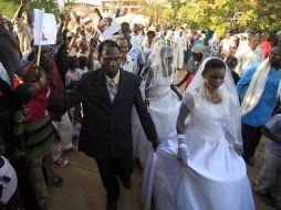 En la imagen algunas de las parejas bailan en su entrada al lugar de la ceremonia, acompañados de familiares y amigos. REUTERS  /