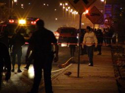 Peritos forenses y policías federales inspeccionan la escena en torno al cuerpo del alto funcionario. EFE  /