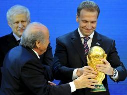 El presidente de la FIFA Joseph Blatter (izq.) cede la Copa del Mundo al primer ministro de Rusia, Igor Shuvalov. EFE  /