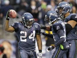 Marshawn Lynch es felicitado por sus compañeros al anotar para Seattle en elpartido de hoy. AP  /