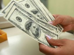 El dólar lo compran en 11.82 pesos. ARCHIVO  /