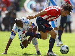 Héctor Reynoso (der), de Chivas, lucha por el balón contra Felix Borja del Puebla, durante el partido en el que se midieron. AFP  /