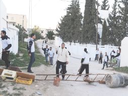 Vecinos de la ciudad La Gazella, forman barricadas para protegerse de saqueadores. AFP  /