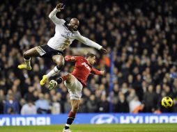 El 'Chicharito' Hernández lucha por el dominio del esférico ante William Gallas del Tottenham. APF  /