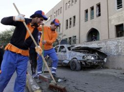 Trabajadores barren los escombros después de los atentado en Bagdad, Irak. AP  /