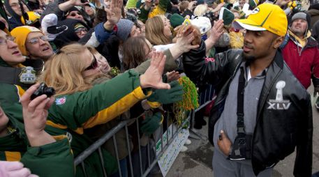 La ciudad sede d ela NFL más chica de Estados Unidos recibió ayer a sus héroes. Charles Woodson saluda a la afición. AP  /