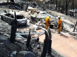 Bomberos observan los destrozos que han dejado los incendios en la ciudad australiana Perth. AP  /