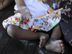 Lei Yadi Min, de 16 meses, juega en una silla en su casa en el poblado de Okalarpa del Sur. AP  /