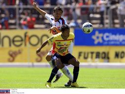 Joao Rojas (de frente) cubre la pelota, ante la marca de Daniel Guerrero. MEXSPORT  /