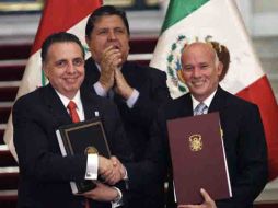 Bruno Ferrari (izquerda), durante la firma del convenio comercial. Atrás se congratula el presidente de Perú, Alan García. AFP  /
