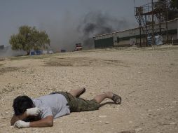 Un hombre yace en el suelo a medida que sube el humo de una explosión desde la Franja de Gaza. AP  /