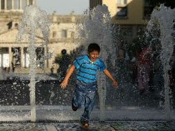Un niño se refresca en una de las fuentes de Plaza Tapatía debido al calor. ARCHIVO  /