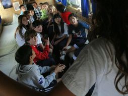 Un grupo de niños observa el interior del autobús en las instalaciones del American School. A. HINOJOSA  /