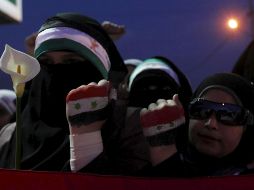 Unas mujeres muestran sus manos pintadas con la bandera siria. EFE  /