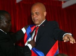 Michel Martelly recibe la banda presidencial del presidente del Senado, Jean Rodolphe. AFP  /