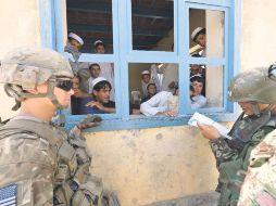 Militares estadounidenses socializan con vecinos en una aldea afgana. AFP  /