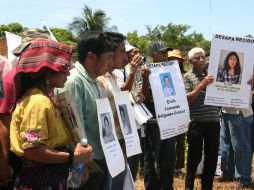 Integrantes de  la Caravana paso a paso hacia la paz muestran pancartas con las señas particulares de familiares desaparecidos. EFE  /