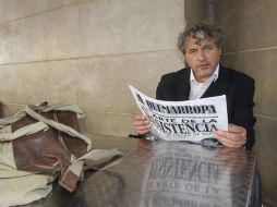 Rivas ojea el periódico oficial del certamen 'A quemarropa'tras la presentación de su novela. EFE  /