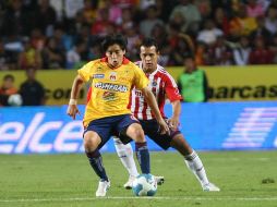 El centrocampista Damian Manso (frente) de Morelia disputa un balón con Mario de Luna (atrás) de Chivas. EFE  /