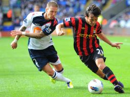 David Silva y Sergio 'Kun' Agüero, lideraron la victoria del Manchester City en el Reebok Stadium. AFP  /