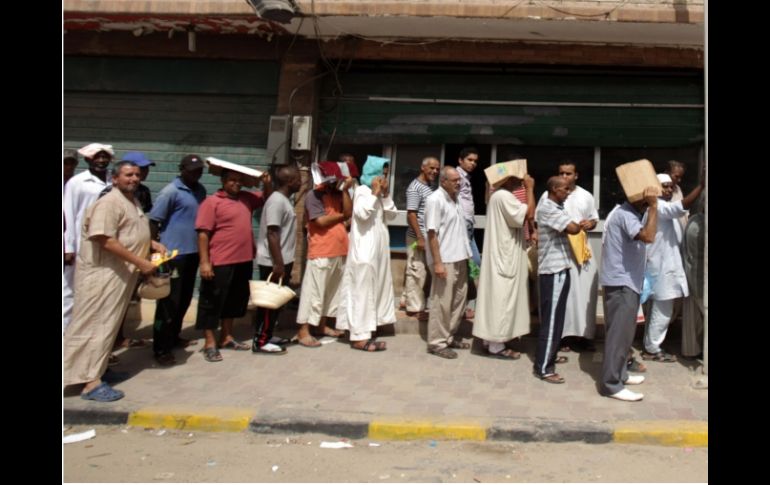 La OIM alertó de miles de personas que desean ser evacuadas de Trípoli ante los disturbios en Libia. AFP  /