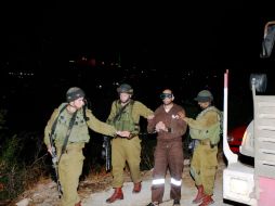 Soldados israelíes escoltan a Hussein Kawasmeh sospechoso de ser integrante de Hamás. AP  /