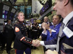 El sargento del Cuerpo de Marines Dakota Meyer, estrecha la mano con los comerciantes antes de sonar la Bolsa de Nueva York. AP  /