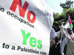 Palestinos se manifiestan frente a la sede de Naciones Unidas en Gaza, Cisjordania. AFP  /