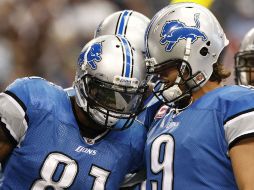 Matthew Stafford y Calvin Johnson (81) celebran el regreso a la senda del tiunfo de su equipo. AP  /