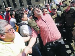 Un manifestante es detenido por carabineros durante los incidentes frente al Palacio de La Moneda en Santiago de Chile. EFE  /