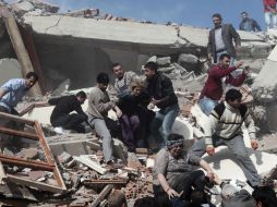 Residentes tratan de salvar a personas dentro de un edificio colapsado después del sismo en Van. EFE  /
