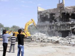 Varios libios toman fotografías de la destrucción de la casa de Gadhafi, en Trípoli. EFE  /