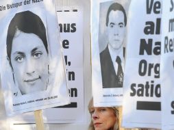 Manifestantes sostienen carteles con fotos de supuestas víctimas del grupo neonazi. ARCHIVO  /