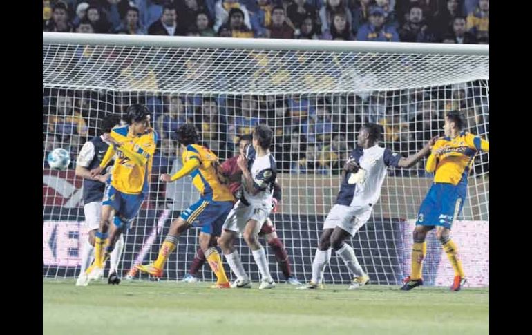 Manuel Viniegra (centro de amarillo) remata de cabeza el esférico para marcar el primer tanto felino. MEXSPORT  /