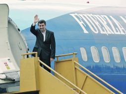 El mandatario iraní dice adiós a los medios y la gente reunida en el aeropuerto, a su salida de Quito, Ecuador. AP  /