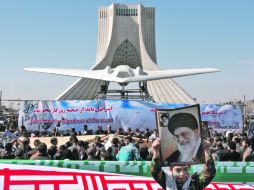 Cientos de miles de personas desfilan con una réplica del avión no tripulado de Estados Unidos que Irán capturó el pasado diciembre. AP  /